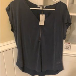 Blue suede like blouse with zip up accent.